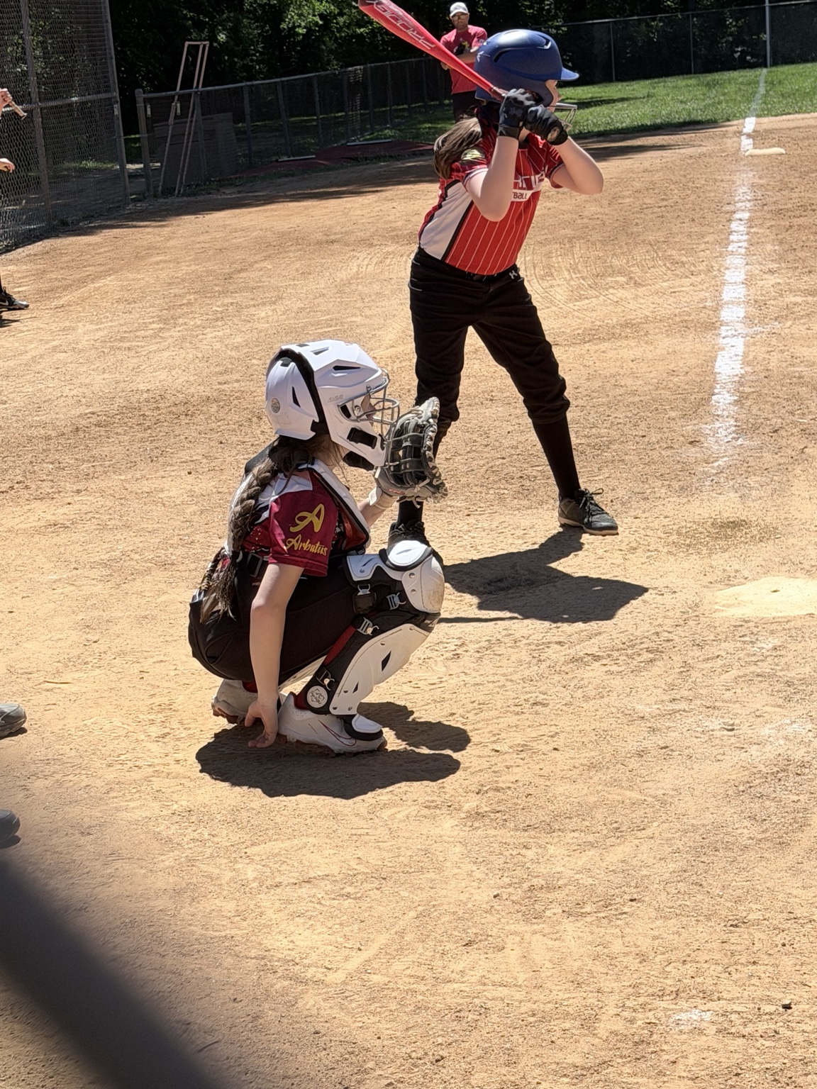 Lady Eagles catcher set behind home plate during a game