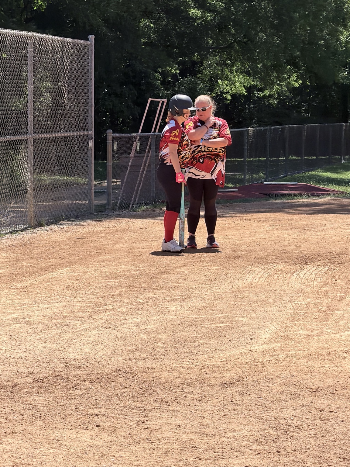 Lady Eagles coach encouraging a player near home plate