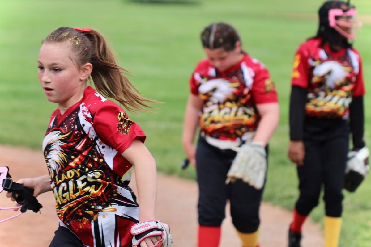 Lady Eagles players coming off the field together
