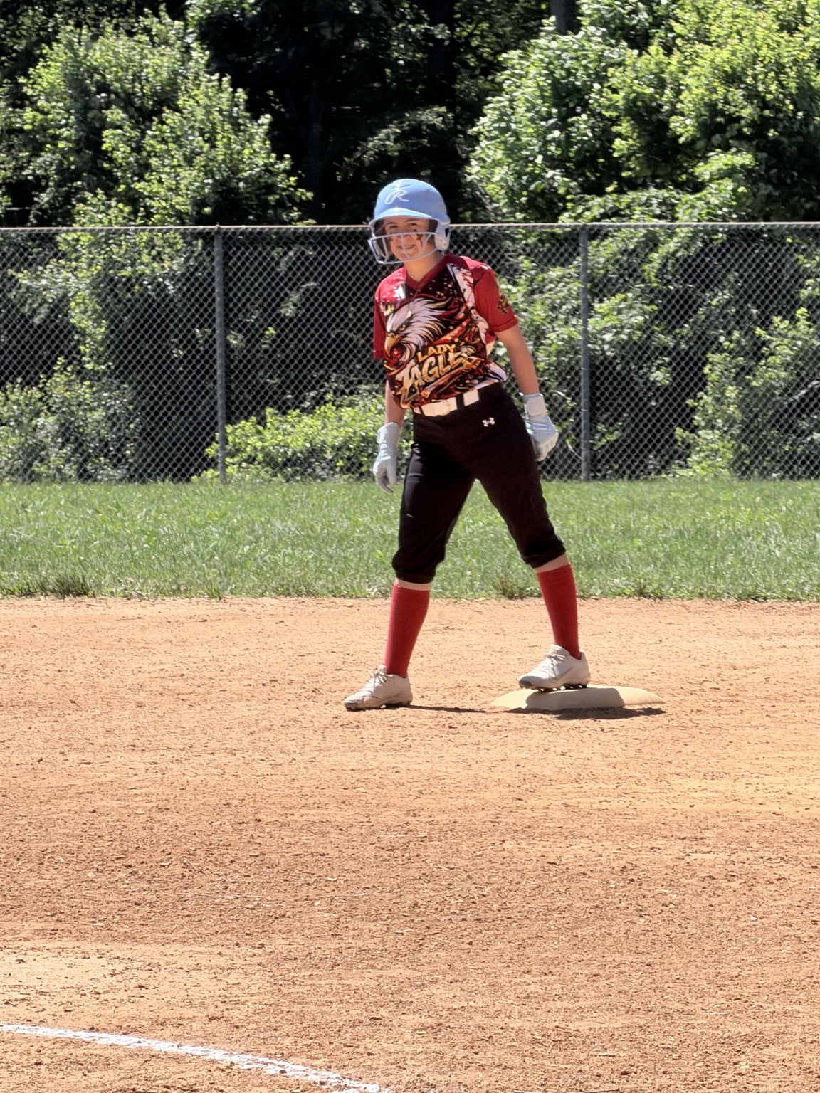 Lady Eagles runner smiling and ready on base