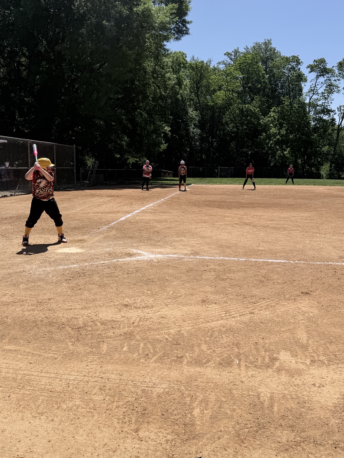 Lady Eagles batter and teammates set across the infield